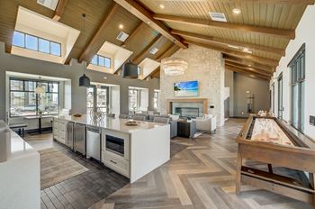 A large kitchen and living room with a fireplace
